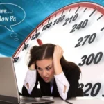 A person looking frustrated while using a slow computer, illustrating the need to fix performance issues