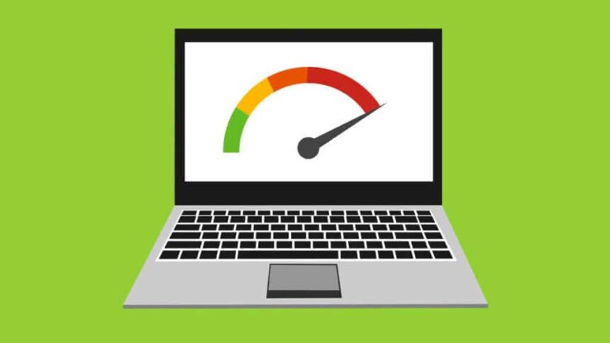 A frustrated person looking at a slow, loading laptop screen with an hourglass icon, representing the need to make the laptop run faster