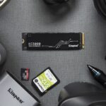 An internal NVMe SSD being installed into the motherboard of a computer, highlighting the process of a storage upgrade.