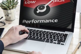 A professional working productively on a fast laptop in a bright, modern office, illustrating the positive results of improved computer performance