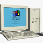 A large pile of electronic waste, including old computer monitors and keyboards, in a landfill, showing the environmental impact of improper disposal.