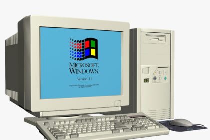 A large pile of electronic waste, including old computer monitors and keyboards, in a landfill, showing the environmental impact of improper disposal.